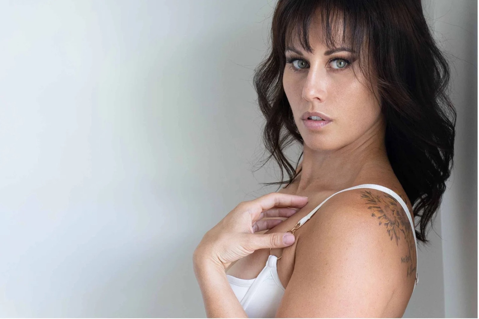 Soft colour boudoir portrait with relaxed eye contact